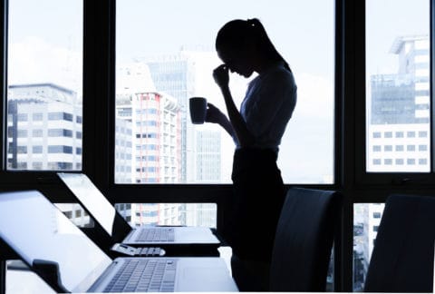 woman with head in her hands thinking Cognitive behavioural therapy London - woman with head in her hands thinking
